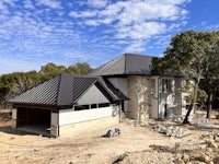 a house under construction with a metal roof