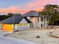 a home with a garage and driveway at dusk